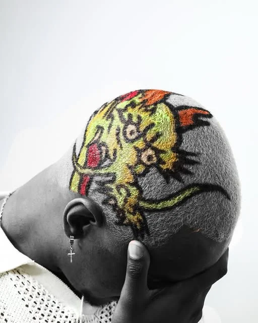 Tiger artwork in yellow, orange and black on a closely cropped haircut