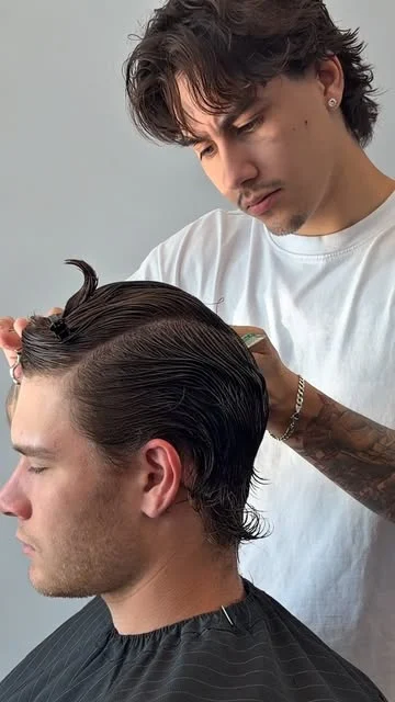 Liam shaping a dark, brushed-back haircut