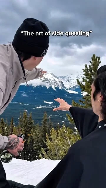 Liam giving a haircut outdoors against a mountain landscape